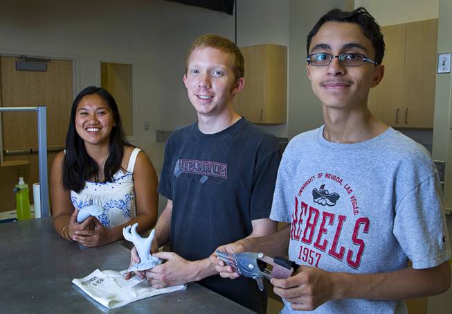 Katherine Lau, a biomedical engineering student from Rutgers University, Zachary Cook, a UNLV mechanical engineering student, and Kareem Trabia, an A-Tech High School senior, at UNLV on Thursday, July 17, 2014. The team is designing a "robohand" for 4-year-old Hailey Dawson using the school's 3D printer. Dawson was born with a birth defect that left her only with a thumb and pinky on her left hand.