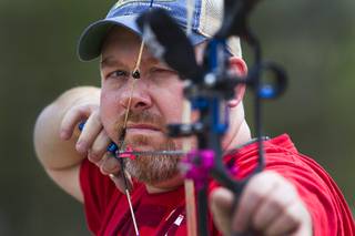 Jeremy Beard, president of the Las Vegas Archers, takes aim at the Las Vegas Archers Spring Mountain Range near Mountain Springs Sunday, July 20, 2014.