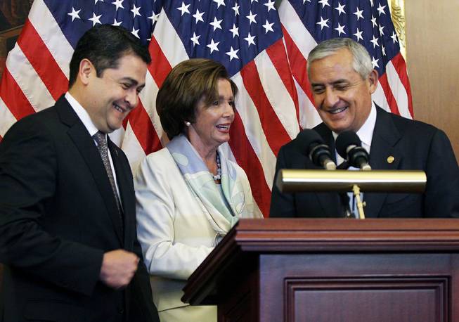 House Democratic Leader Nancy Pelosi, D-Calif., center, is seen with Guatemalan President Otto Molina, right, and Honduran President Juan Hernández on Thursday, July 24, 2014 on Capitol Hill in Washington. The Obama administration is weighing giving refugee status to young people from Honduras as part of a plan to slow the influx of unaccompanied minors arriving at the U.S.-Mexico border, White House officials said Thursday. 