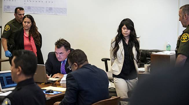 Candace Marie Brito, 27, left, and Vanesa Tapia Zavala, 26, enter court in Santa Ana, Calif., Wednesday morning, July 9, 2014, for the start of their trial. 