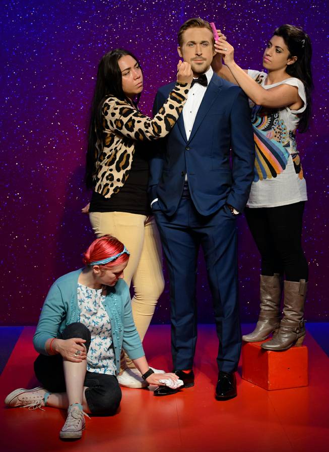 AP10ThingsToSee - Final adjustments are made to the wax figure of Canadian actor Ryan Gosling by Jane Anderson, left, Gemma Sim, center, and Caryn Bloom, right, at Madame Tussauds, London, Wednesday, July. 23, 2014. 