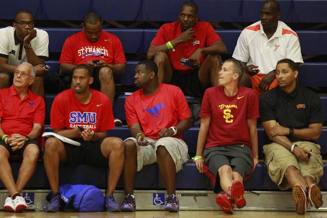 UNLV assistant coach Stacey Augmon, top row, second from right, watches the Showtime Ballers take on New Heights during their game at the Las Vegas Fab 48 tournament Friday, July 25, 2014.