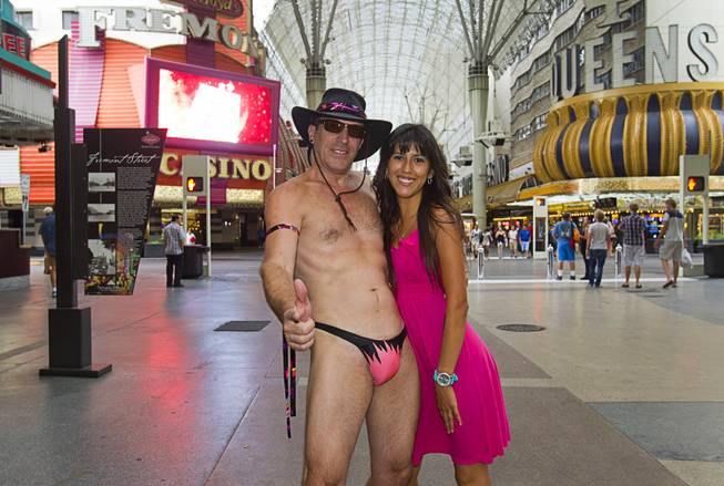 "Lucky Joe" poses with Gina Lopez of Fresno, Calif at the Fremont Street Experience Sunday, July 27, 2014. Lucky Joe said he is retired and poses just for fun (and tips).