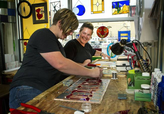 Owners Ellisha Haddix and Mya Daily of stained glass business Lead In the Window work on their current pieces within Container Park on Friday, July 25, 2014.
