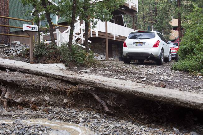 A resident is cut-off from Rainbow Canyon Boulevard in the Rainbow Subdivision on Mt. Charleston Monday, July 28, 2014. The neighborhood was hit hard by flooding and debris in runoff last year as well.