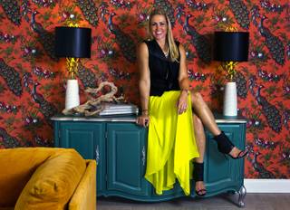Melissa Roche sits on her cabinet in Parlor 430 on Monday, July 28, 2014. She is a local interior designer and Season 2 winner on HGTVs 