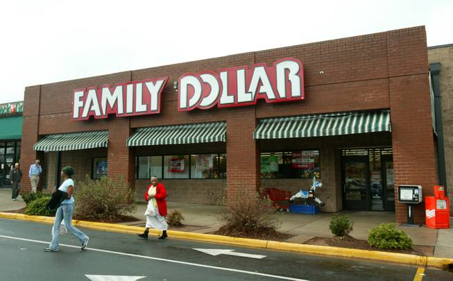 In this Tuesday, Nov. 29, 2005, file photo, customers walk past a Family Dollar store at Hickory Grove Market in Charlotte, N.C. Dollar Tree is buying rival discount store Family Dollar in a cash-and-stock deal valued at about $8.5 billion, the companies announced Monday, July 28, 2014.