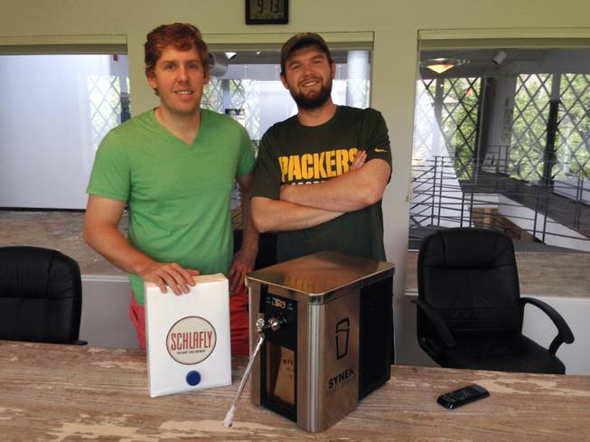 Synek's co-founder Steve Young, left, and Strategic Director Michael Werner show their "Keurig machine for beer," for which a successful Kickstarter campaign has seen them raise more than $648,000 for development, manufacturing and marketing expenses.