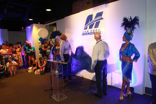 Las Vegas Monorail President and CEO Curtis Myles and board member Pat Shalmy unveil a new logo during the Monorail's 10th anniversary celebration Saturday, July 26, 2014.