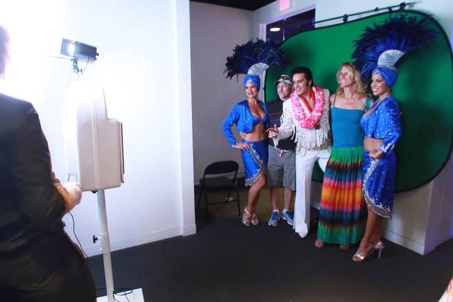 Jason and Jeannette Crawshaw have their photo taken with showgirls Stacey Shea, left, Jennifer Johnson and Elvis impersonator Steve Connolly during the Las Vegas Monorail's 10th anniversary celebration Saturday, July 26, 2014.
