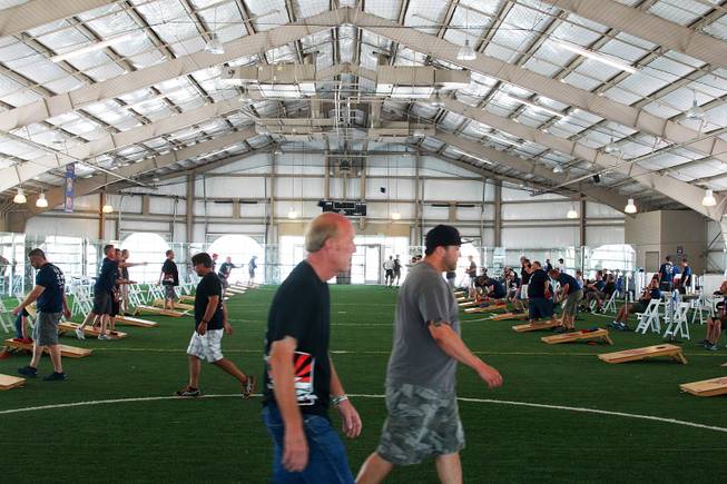 Contestants make their way between boards during a Cornhole tournament Saturday, July 26, 2014.