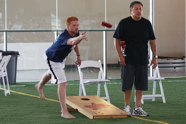 Jeff Link, left, and Andy Hernandez compete during a Cornhole tournament Saturday, July 26, 2014.