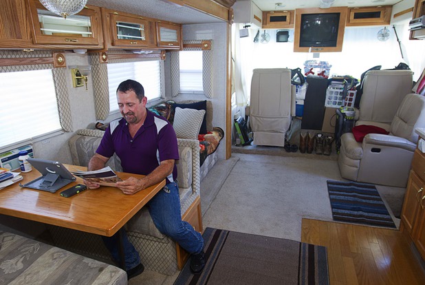 Cass Via, a maintenance worker at the High Roller, looks over a home listing in his RV at the Oasis Las Vegas RV Resort Tuesday, July 29, 2014. Via is in the market for a house but says he will be buying a pre-owned home, not a new one.