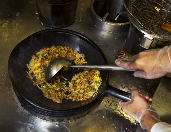 Chef Andy Vu cooks Fried Rice while preparing Chinese food for the Cafe Fiesta at Fiesta Henderson on Monday, July 28, 2014.