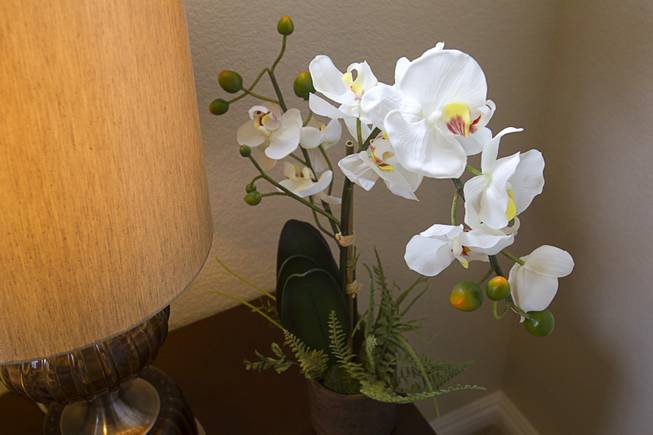 An orchid decorates a guest bedroom in a one-story plan 1849 model home at KB Homes' Tevare residential development in Summerlin Wednesday, July 30, 2014.