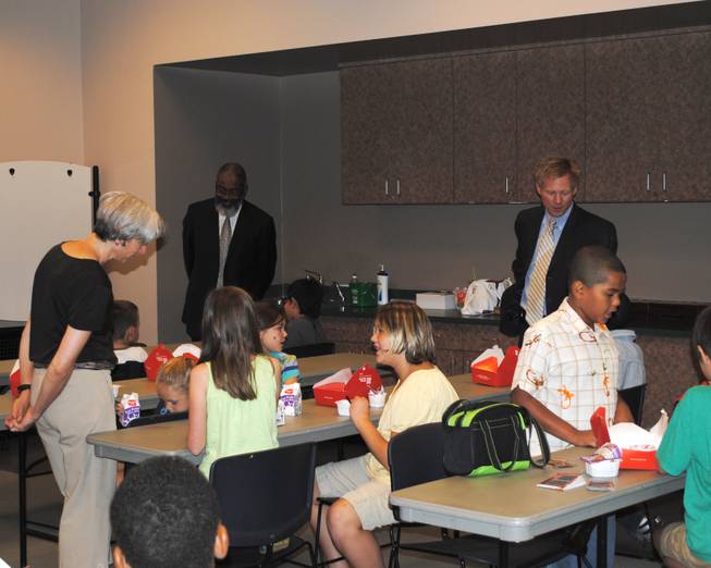 Assistant Secretary of Agriculture for Administration Dr. Greg Parham and StrikeForce National Coordinator Max Finberg mingle with students during the USDA's visit to Cambridge Recreation Center for Three Square Food Bank's Summer Food Service Program.