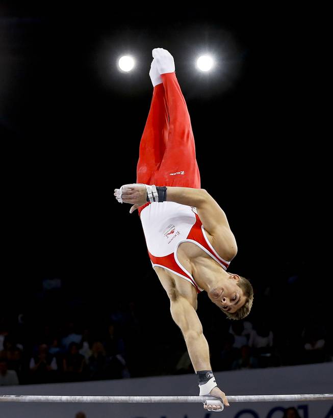 Gold medal winner Max Whitlock of England performs on the horizontal bar during the Men's All-Around gymnastics competition at the Scottish Exhibition Conference Centre during the Commonwealth Games 2014 in Glasgow, Scotland, Wednesday July 30, 2014. 