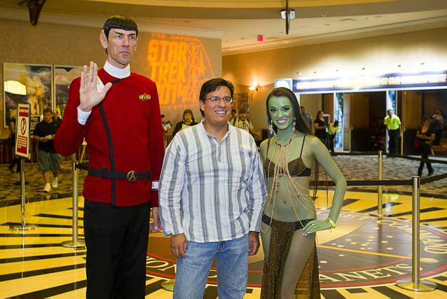 Jaime Bastides, center, of Saylorsburg, Penn. poses with "Spock Vegas" (Paul Forest) and an Orion slave girl (Joanie Brosas) during the 13th annual Official Star Trek Convention at the Rio Thursday, July 31, 2014. The convention, expected to attract 15,000 Trekkies, runs through Sunday.