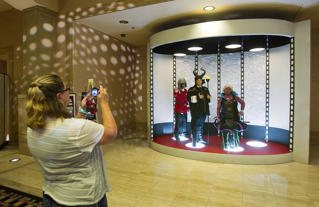 Fans have their photo taken in a mock transporter during the 13th annual Official Star Trek Convention at the Rio Thursday, July 31, 2014. From left are: Jim Cartwright of Hesperia, Calif., Chris Dickson of Costa Mesa, Calif. and Donna Long of Hesperia, Calif.