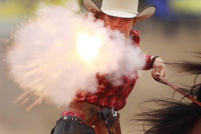 Breanna Coston fires at a target during the Cowboy Mounted Shooting Association's Western U.S. ChampionshipThursday, July 31, 2014 at the South Point.