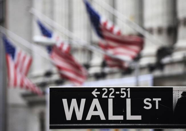 This April 22, 2010, file photo shows a Wall Street sign in front of the New York Stock Exchange. 