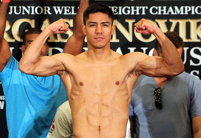 Undefeated WBA Jr. Welterweight champion Jessie Vargas flexes on the scale during an official weigh-in at the Cosmopolitan Friday, August 1, 2014. Vargas will defend his title against the undefeated Anton Novikov of Chelyabinsk, Russia in the Chelsea at the Cosmopolitan Saturday.