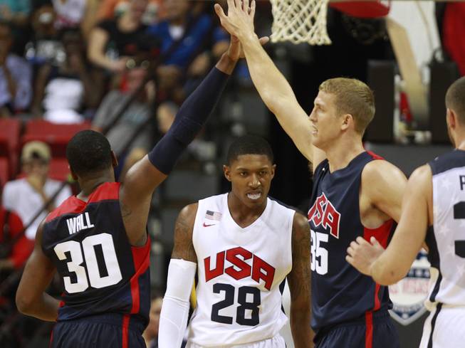 John Wall and Mason Plumlee celebrate after drawing a foul from Bradley Beal, center, during the 2014 USA Basketball Showcase Friday, Aug. 1, 2014 at the Thomas & Mack Center.