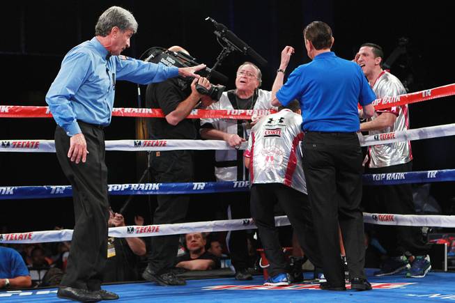 Referee Vic Drakulich warns Diego Chaves's corner between the eighth and ninth round of his welterweight fight against Brandon Rios Saturday, Aug. 2, 2014 at the Cosmopolitan. Rios won after Chaves was disqualified in the ninth round.