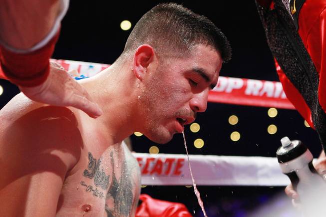 Brandon Rios spits water between rounds of his welterweight fight against Diego Chaves Saturday, Aug. 2, 2014 at the Cosmopolitan. Rios won after Chaves was disqualified in the ninth round.
