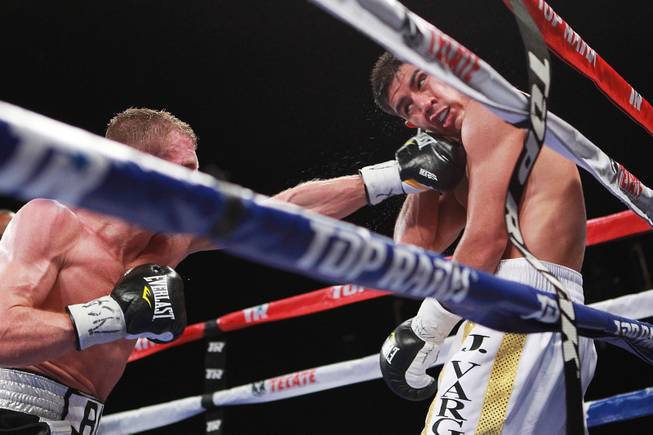 Jessie Vargas is hit by a left from Anton Novikov during their WBA light welterweight title fight Saturday, Aug. 2, 2014 at the Cosmopolitan. Vargas won by decision.