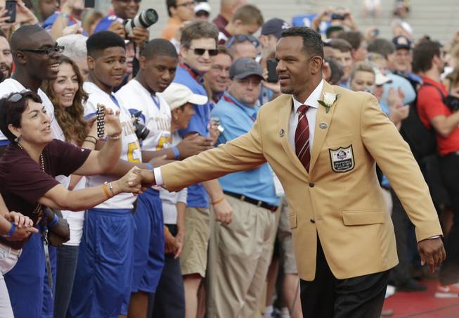 Hall of Fame Inductee Andre Reed greets fans as he is introduced during the 2014 Pro Football Hall of Fame Enshrinement Ceremony at the Pro Football Hall of Fame on Saturday, Aug. 2, 2014, in Canton, Ohio.