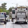 An ambulance leaves the scene of an officer-involved shooting Sunday, Aug. 3, 2014, near Pecos and Alexander roads.
