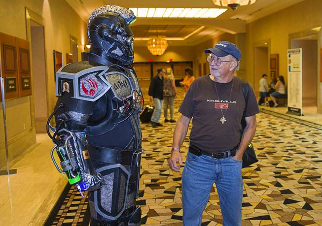 Joe Kopa of Las Vegas looks over an armored Borg concept suit worn by Jerry Powell of Costa Mesa, Calif. during the final day of the 13th annual Official Star Trek Convention at the Rio Sunday, Aug. 3, 2014. The suit is mostly made from cut-up pieces of a Sears workout mat, Powell said.