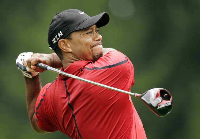 Tiger Woods watches his his tee shot on the fourth hole during the final round of the Bridgestone Invitational golf tournament Sunday, Aug. 3, 2014, at Firestone Country Club in Akron, Ohio.
