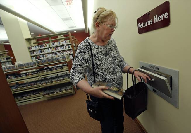 Susan McNamara returns a book to the public library in Quincy, Mass. “Over the years, all I’ve been able to do, especially as a single parent, is just pay your bills every month,” said McNamara, a 62-year-old adjunct professor from the Boston area. “Anything that’s left over is used up when your car breaks down or when the furnace breaks down ... There’s never anything left over, ever.”