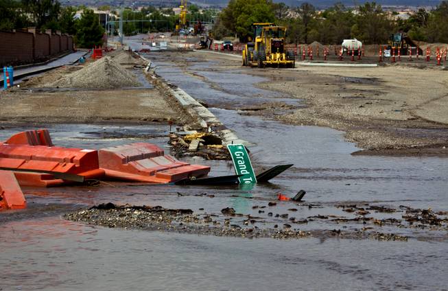 Road signs are down as flooding still continues due to recent heavy rains along West Grand Teton Drive at the intersection of North Tenaya Way on Monday, August 4, 2014.