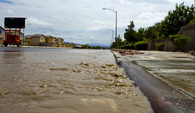 Flooding still continues from recent heavy rains along West Grand Teton Drive at the intersection of North Quail View Street on Monday, August 4, 2014.