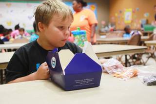 Keaton Beshara eats his lunch during a summer day camp at the Stupak Community Center Tuesday, Aug. 5, 2014.