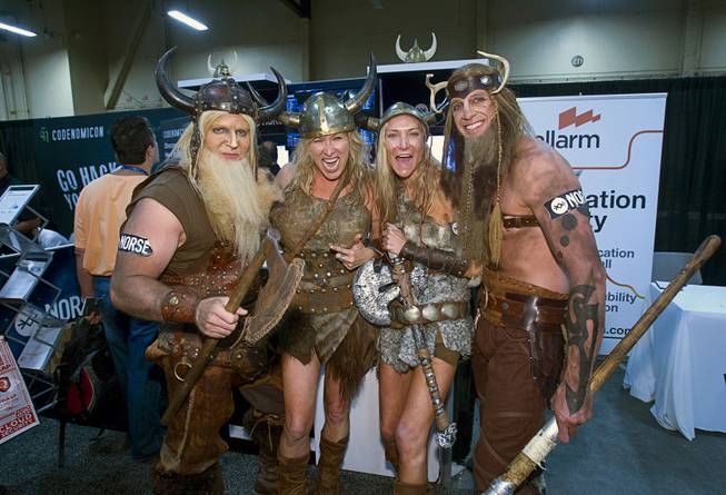People dressed as vikings pose in front of the Norse booth during the Black Hat USA 2014 hacker conference at the Mandalay Bay Convention Center Aug. 6, 2014. Norse is a computer security company that provides live attack intelligence. From left are: Matt Nelson, Lacy Younger, Maria Herman, and Marty Windham.