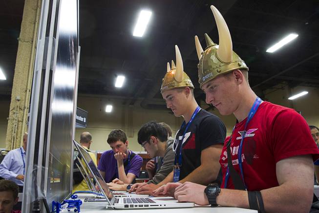 K.C. McGaffey, center, and John Dimmer, right, compete in the "Hacker Kombat" challenge at the WhiteHat Security booth during the Black Hat USA 2014 hacker conference at the Mandalay Bay Convention Center Aug. 6, 2014.