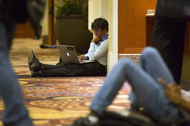 Utkarsh Sanghi, a security engineer at Google, works in a hallway during the Black Hat USA 2014 hacker conference at the Mandalay Bay Convention Center Aug. 6, 2014.