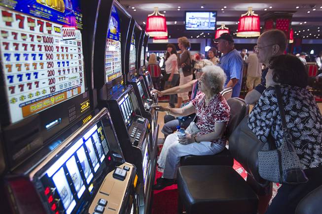 Gamblers try their luck with slot machines during the opening of the casino floor at the Cromwell, formerly Bill's Gamblin' Hall & Saloon, on the Las Vegas Strip and Flamingo Avenue, Monday, April 21, 2014.