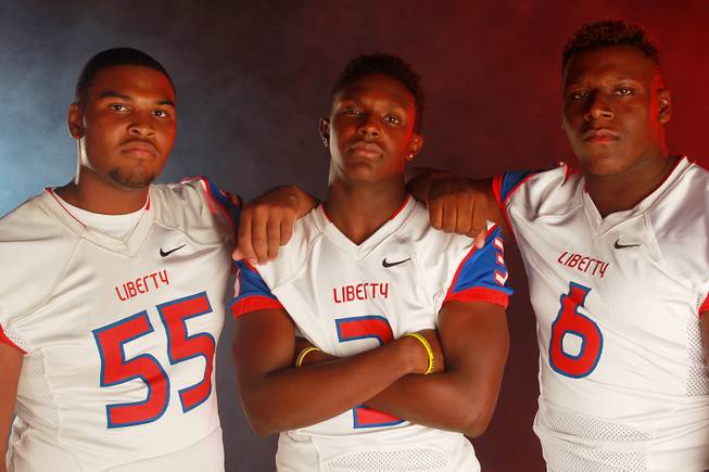 From left, Liberty High School football  players Joshua Bernard, Bryan Roland and Calvin Tubbs July 21, 2014.