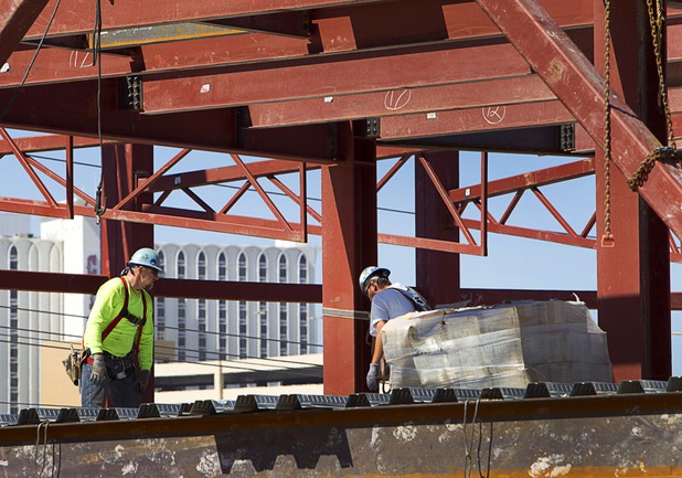 Iron workers are shown during construction of a building at the northeast corner of Sahara Avenue and Las Vegas Boulevard South Thursday, August 7, 2014. A Walgreens will occupy about half of the first floor. Wilger Enterprises is the general contractor on the project.