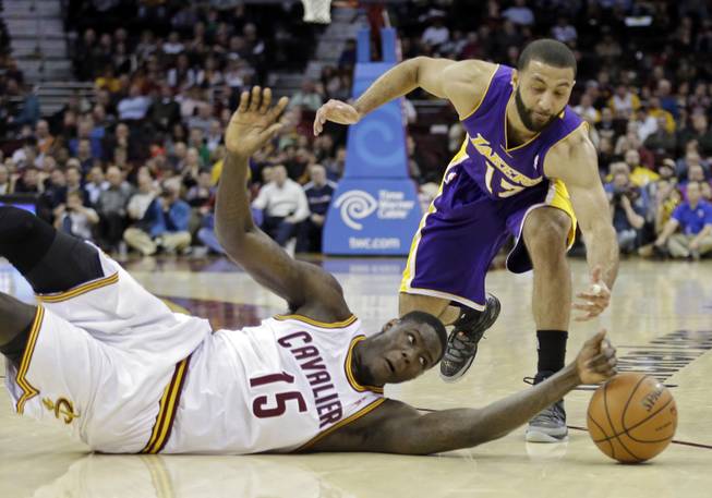 The Cleveland Cavaliers' Anthony Bennett (15) bats a loose ball away from the Los Angeles Lakers' Kendall Marshall in the fourth quarter of an NBA basketball game on Wednesday, Feb. 5, 2014, in Cleveland.