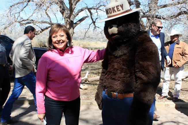 Gov. Susana Martinez prepares to take a photograph with Smokey Bear after a news conference in Albuquerque on Monday, March 31, 2014. Martinez urged residents to be cautious as the state heads into another potentially dangerous fire season. 