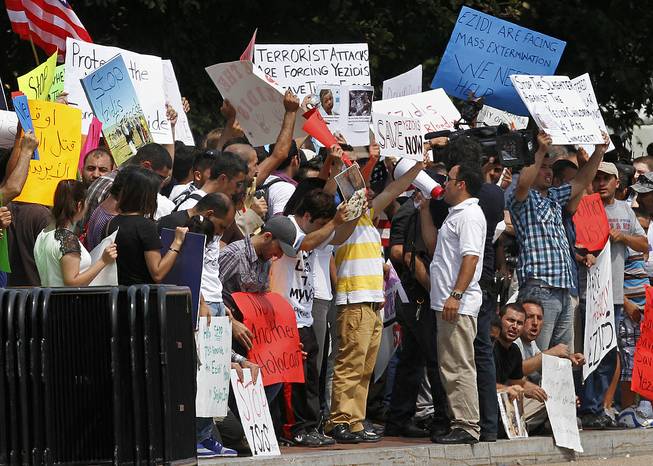 Protesters ask for help for Yazidi people who are stranded by violence in northern Iraq, Thursday, Aug. 7, 2014, across from the White House in Washington. 
