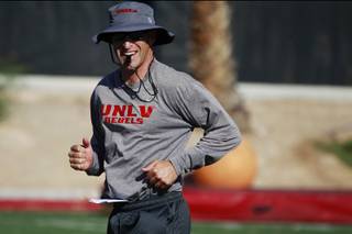 UNLV head coach Bobby Hauck smiles during practice Friday, Aug. 8, 2014.