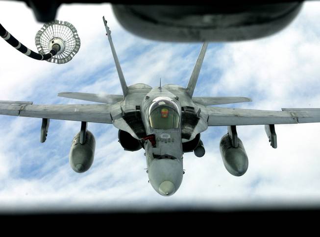 An FA 18 Hornet approaches to get airborne refueling from a KC 10 Tanker of U.S. Airforce 2nd Air Refuelling Squadron, based in Andersen Air Force Base in Guam, during the "Valiant Shield 06" exercises in the Pacific Ocean, off Guam coast,  Friday, June 23, 2006.