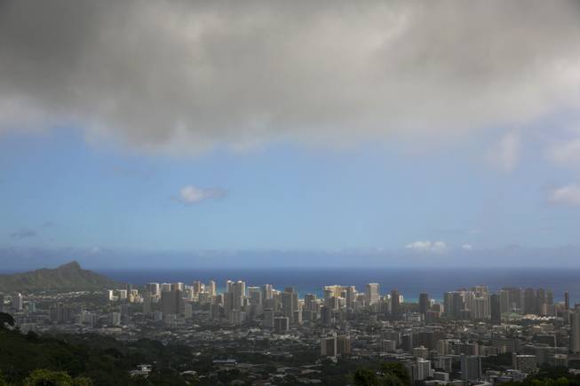 Clouds hang over Honolulu, seen from the top of Tanalus Drive on Thursday, Aug. 7, 2014, before  Tropical Storm Iselle makes landfall on Friday, Aug. 8, 2014. Tracking close behind it is Hurricane Julio.